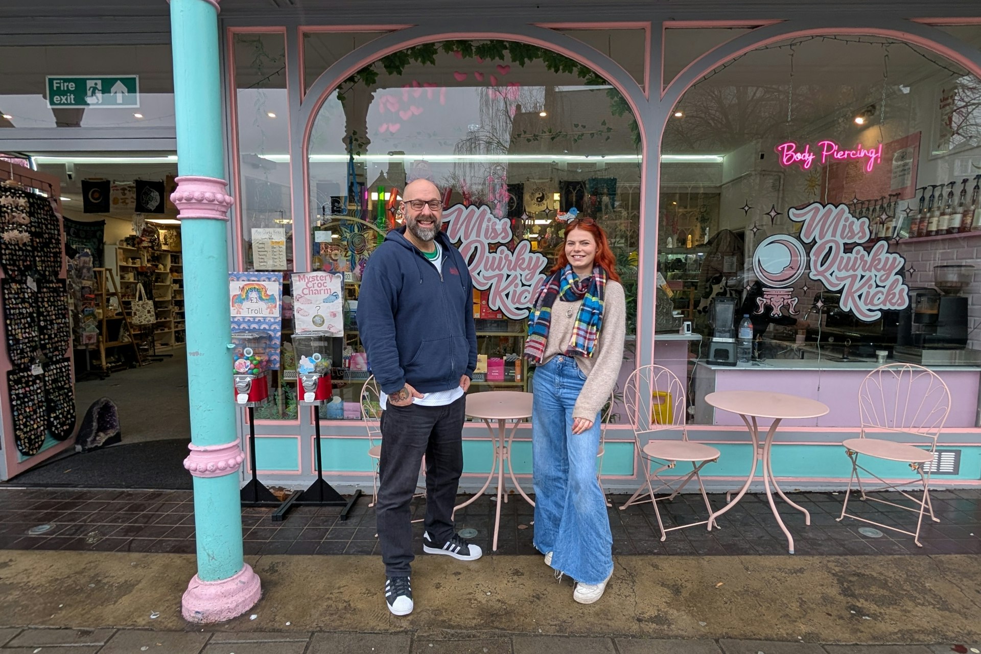 Two people stood outside shop
